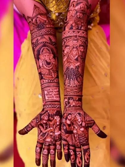 A detailed design featuring a Ganesha figure, family portraits, and scenes from the wedding ceremony.