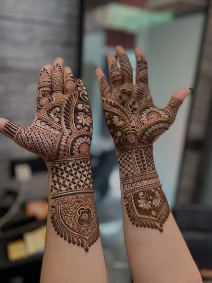 This design shows a beautiful contrast between the two hands, one with a large central motif and the other with flowing paisley patterns.