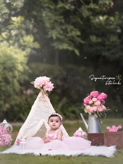 My outdoor sessions are designed to be whimsical and beautiful. This portrait features a baby girl in a boho-chic setup with a lace teepee and floral arrangements. The soft, natural light and curated props create a dreamy, aesthetic look perfect for milestone photos.