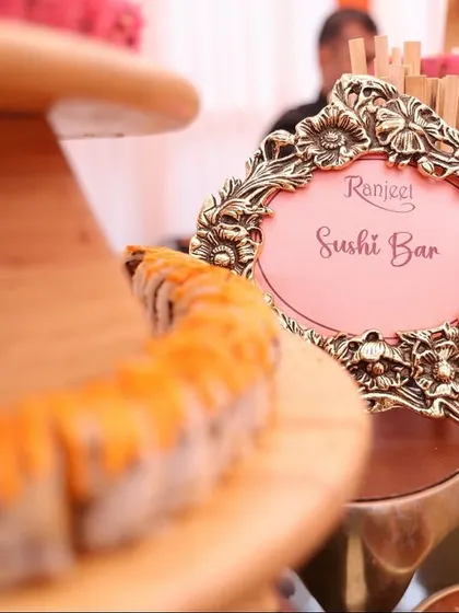 Our culinary offerings extend far beyond traditional Indian cuisine. This elegant live Sushi Bar, complete with an ornate sign, showcases our expertise in crafting authentic and sophisticated global food experiences for weddings.