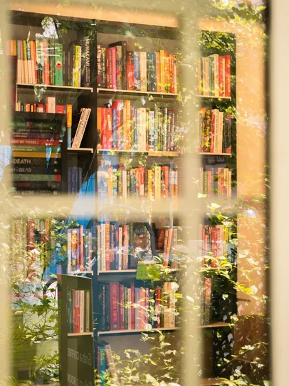 A peek through the window at the warm lights and bookshelves inside. It’s that feeling of comfort and escape that I love.
