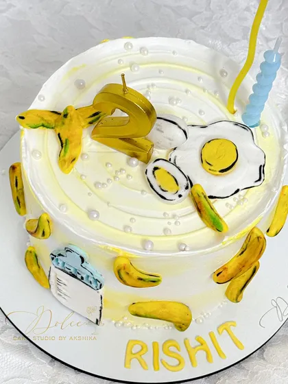 A top-down view of the fun and customized "favorite things" cake, showing the fried egg and banana details.