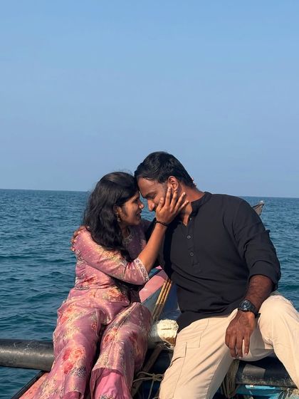 An intimate and romantic moment captured during a mid-sea boat ride, with the endless ocean as a backdrop.