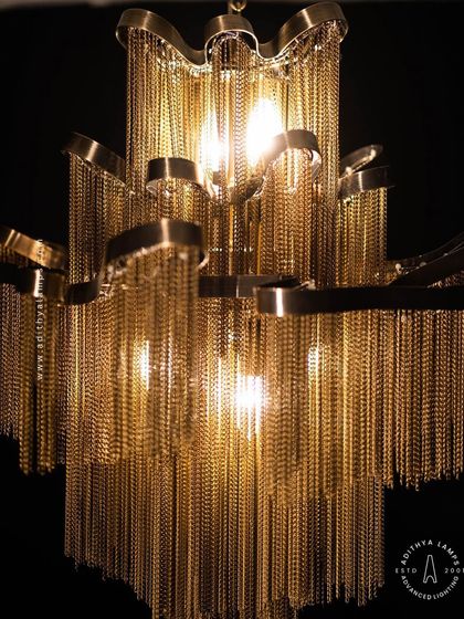 This chandelier makes a bold statement with its cascading antique gold chains. The layers of chains create a fluid, waterfall-like effect that beautifully diffuses the light, adding texture, warmth, and a touch of vintage glamour to your interior.