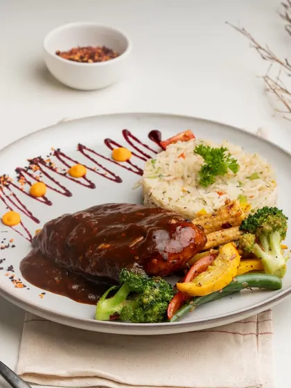For our steakhouse evenings, I wanted to create something special. This is my signature steak, seared to perfection, coated in a rich, savory sauce, and served with herbed rice and sautéed seasonal vegetables.