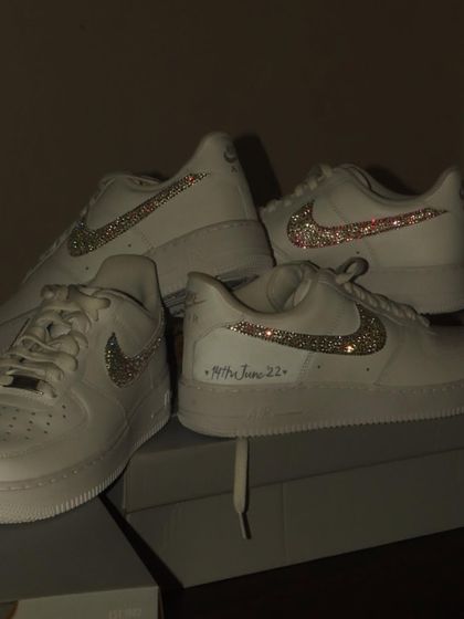 Iced out Forces. For this project, I customized two pairs of Nike Air Force 1s for a client by carefully applying sparkling crystals all over the swoosh, and adding a special date.