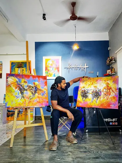 Here I am in my studio with two of my proudest creations celebrating Tulunadu culture. On the left is the 'Koroda Katta' and on the right is my 'Kambala' painting, both ready to find a new home.