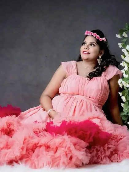 Celebrate your journey to motherhood with a beautiful maternity shoot. Here, we used a dark, moody backdrop and simple props like the birdcages to create a soft, artistic portrait that focuses on the joy of this special time.
