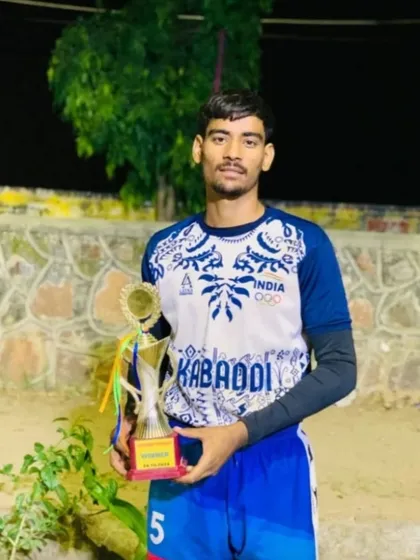 An academy player wearing the India training jersey, holding his trophy after being selected for the Under-18 National Championship.