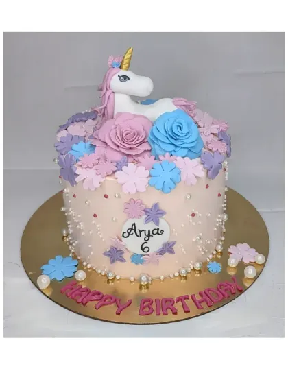 A floral unicorn cake for a 6th birthday. This eggless chocolate truffle cake is decorated with a handmade fondant unicorn surrounded by a crown of colorful flowers.