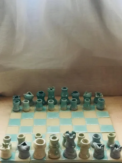 Who says a game of chess can't be charming? I crafted this "Cocoa Clash" ceramic chessboard with quirky, wobbly warriors and soft pastel glazes to bring a playful touch to a classic game.