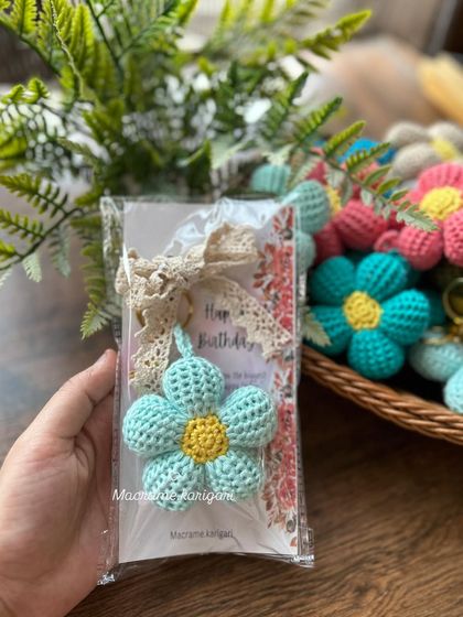 This light blue puff flower keychain is another example of our popular gift items. The crochet lace tie adds an extra touch of elegance.