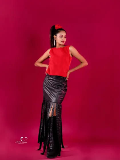 A strong, full-length standing pose that exudes confidence. The hands on her hips add to the powerful attitude.