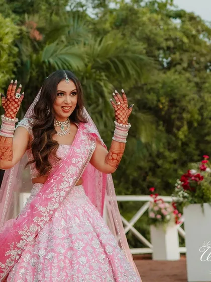 The bride's joyful expression as she makes her entrance. Her hands raised in celebration perfectly capture the excitement of the moment she walks towards her new life.