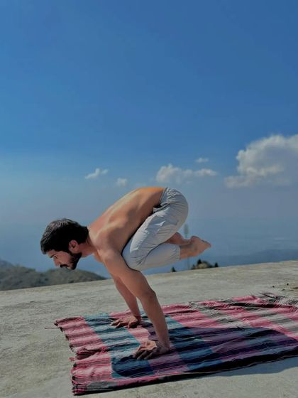 Bakasana (Crane Pose) practiced outdoors. Balancing on my hands connects me to the earth, requiring core strength and unwavering concentration.