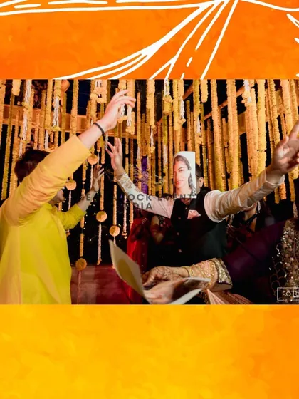 Pure joy and celebration during a Haldi event I planned. The guests are dancing and having a great time against the backdrop of festive floral decorations.
