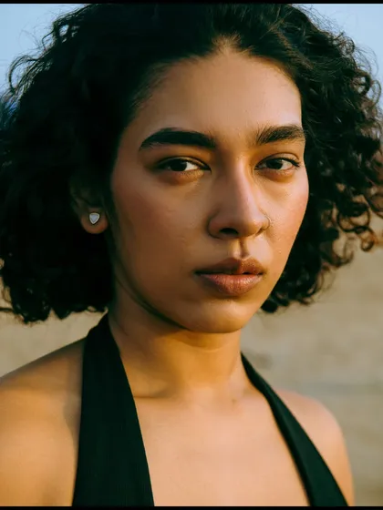 A simple, honest, and direct portrait taken outdoors. The natural light is clean and even, focusing all the attention on the model's unique features and clear gaze. This is a great example of a minimalist, natural beauty shot.