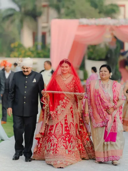 The bride's grand entrance, walking down the aisle with her parents by her side. A poignant and emotional moment.