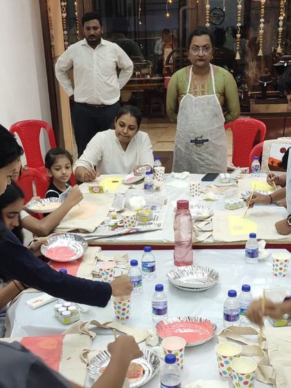 A creative space can be a little messy, and that's part of the fun. This photo captures the busy, happy atmosphere of our children's painting parties.