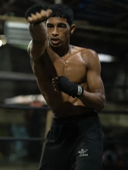 Shadowboxing to perfect form and footwork. This is a fundamental drill for developing muscle memory and fluid movement.