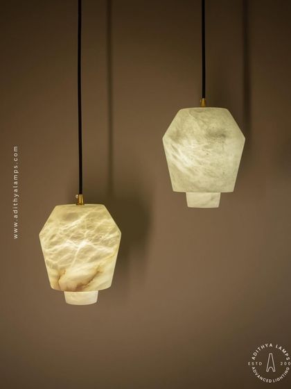 The unique veining of the marble is clearly visible in this shot, highlighting the natural, one-of-a-kind beauty of each pendant light.