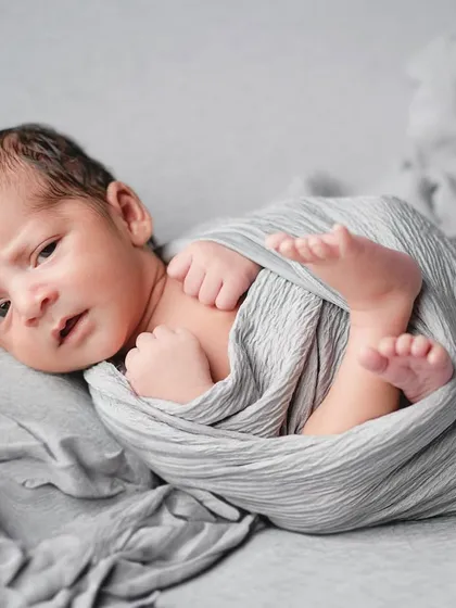 A precious moment of connection as this newborn peeks out from his swaddle. Even when they are awake for a moment, we can capture their beautiful, curious eyes.