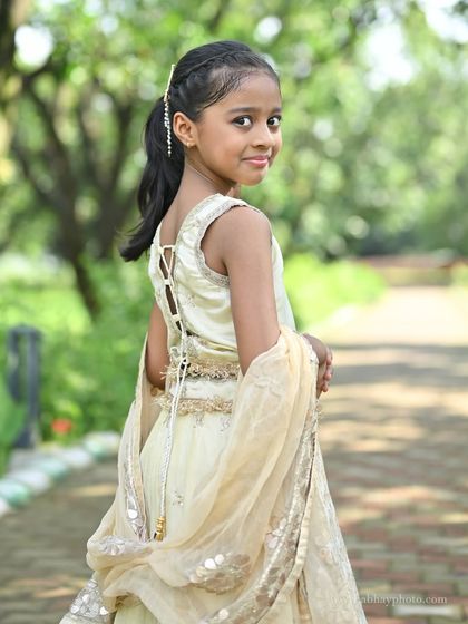 A close-up back view of the ivory kids' lehenga, highlighting the adjustable tie-up back which ensures a perfect fit.