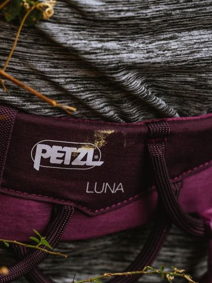 A close-up of a Petzl Luna harness, which is specifically designed for a woman's body. We prioritize providing comfortable and appropriate gear.