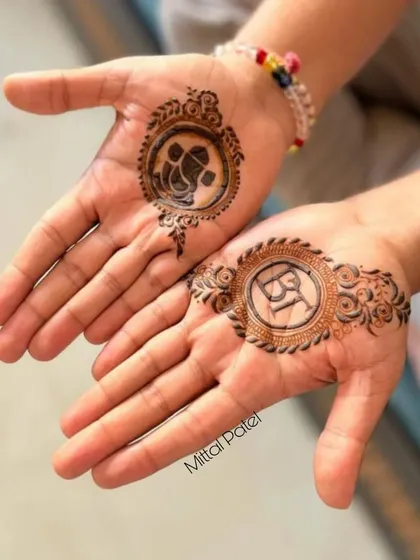 Henna for the groom! This design features a Ganesha motif on one hand and the couple's initials on the other, both inside a neat circular frame.