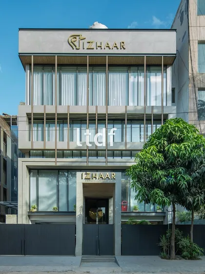 The facade for "Izhaar" is a bold statement of modern commercial architecture. We used a strong composition of concrete, linear metallic elements, and glass to create a visual identity that is both sophisticated and inviting.