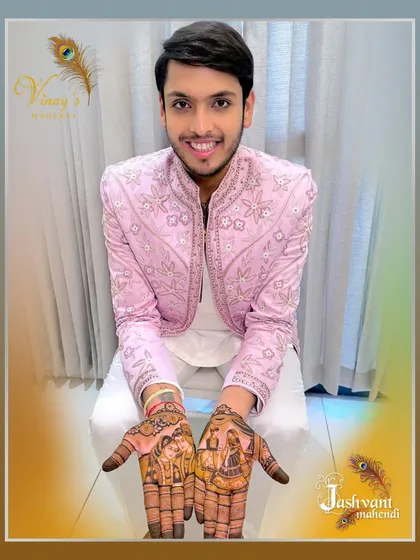Another happy groom showcasing his full-hand portrait mehndi. The joy on his face reflects the beauty of the art.