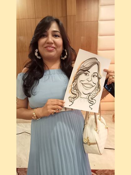 A guest proudly displays her caricature, which captures her stylish earrings and smile. It's a fun, fashionable keepsake.