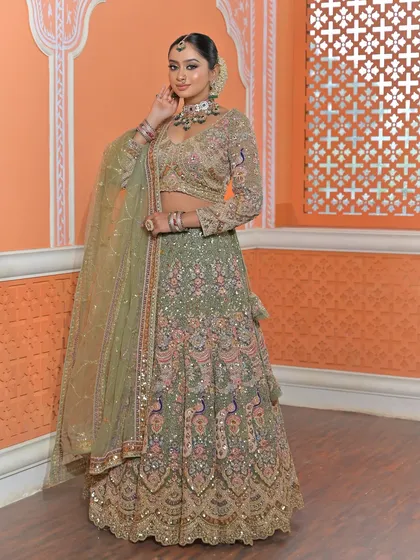 A confident pose showing the full outfit and jewellery set. The peacock embroidery on the lehenga is a beautiful detail that ties in with the traditional aesthetic.