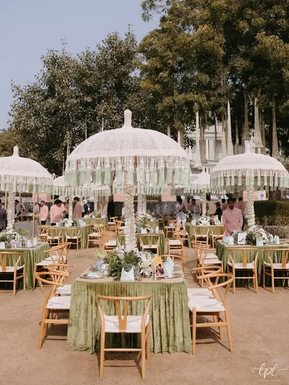 A beautiful daytime event setup with custom-printed linens and elegant fringed umbrellas. We believe every detail, down to the textiles, should contribute to the overall design story.