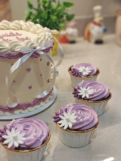 A detail shot showing the coordination between the main cake and the custom cupcakes. I love it when a full dessert table comes together like this.