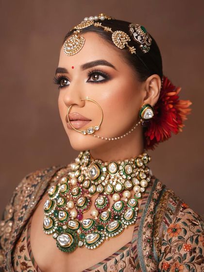The profile of this stunning bride, with a flower in her hair adding a touch of softness.