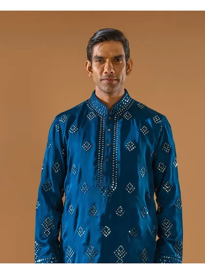 A close-up of the teal mirror-work kurta. This piece is designed to make you shine during the festival of lights, encapsulating the essence of traditional attire with contemporary charm.