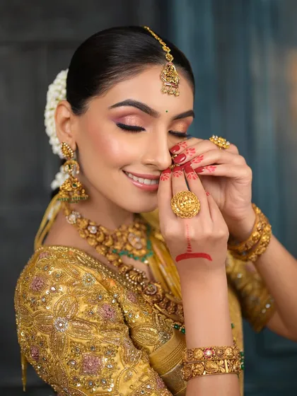 A close-up of the bride's serene expression, with her eyes closed. This shot highlights the soft, blended eyeshadow and the overall peacefulness of the moment.