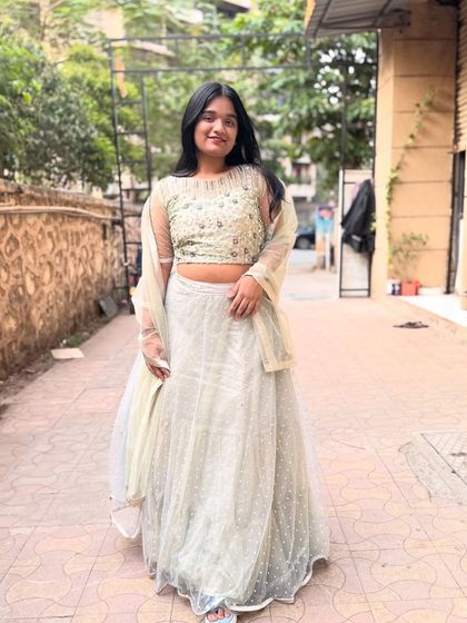 A full-length view of the pista green lehenga. The delicate net fabric and polka dots on the skirt add a touch of modern charm.