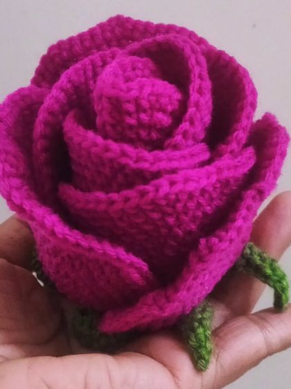 A beautiful, deep pink rose, perfectly formed in the palm of my hand. This is the finished bloom before I add the stem and leaves, showcasing the intricate petal work.