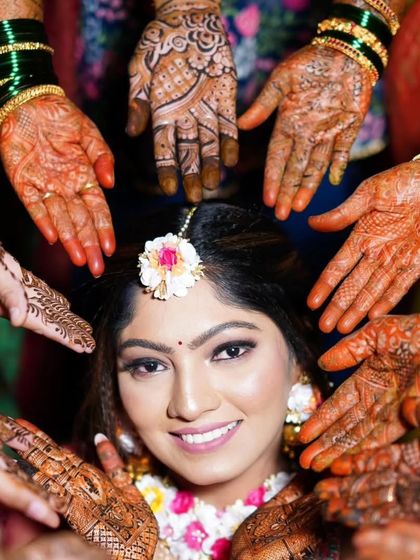 A beautiful shot from a Haldi ceremony, with the bride surrounded by loved ones, all showing off the mehandi we did for the entire bridal party.