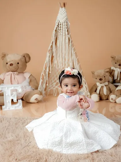 A playful moment as the birthday girl interacts with her props, creating a candid and authentic memory of her special day.