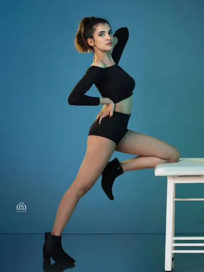 This is where I experiment with colored gels in the studio to create a specific mood. The vibrant blue backdrop and reflective floor produce a high-energy, modern look, perfect for a model's portfolio or an edgy fashion concept.