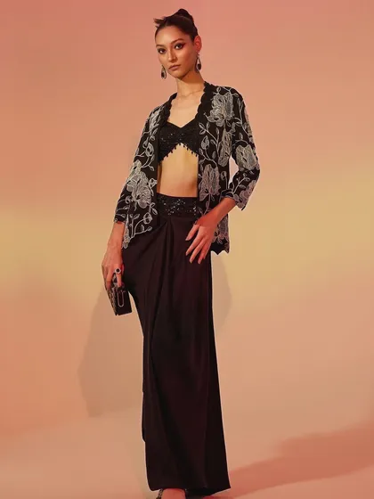 A full-length shot of the modern black ensemble. I added a clutch and statement earrings to complete this chic, party-ready look, focusing on a sharp and sophisticated silhouette.
