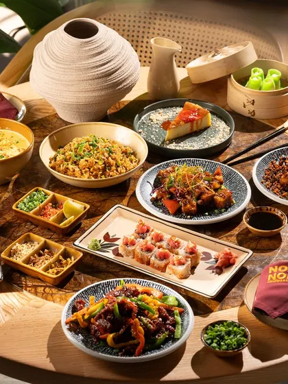 A full-table spread showcasing the variety of a Pan-Asian menu. My goal here is to create a sense of abundance and a feast for the eyes, inviting customers to try everything.