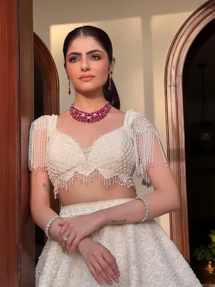 This bride looks absolutely stunning in her white lehenga. The soft glam makeup enhances her features without overpowering, creating a look that is both modern and timeless.