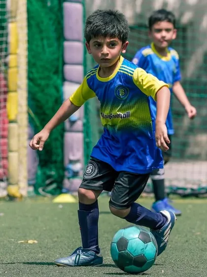 Focus is the difference between good and great. A young player with his eyes on the ball.