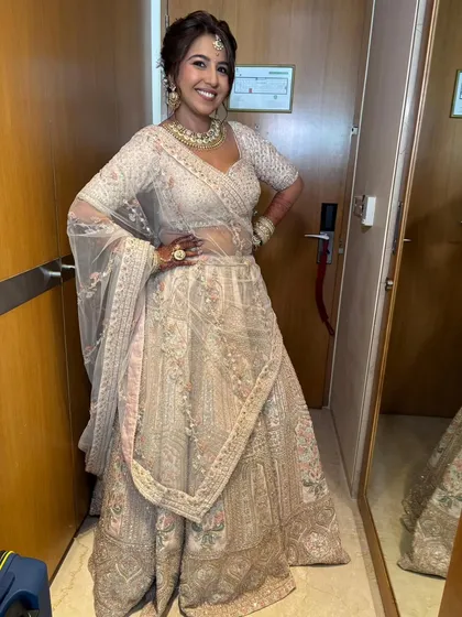 The full look for this bride's daytime event. The light and airy makeup perfectly complements her elegant pastel lehenga, making her look effortlessly chic and radiant.