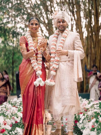 The walk of a lifetime. This happy couple strolls down an aisle lined with flowers after their ceremony, a perfect example of the joyful, seamless experience we strive to create.