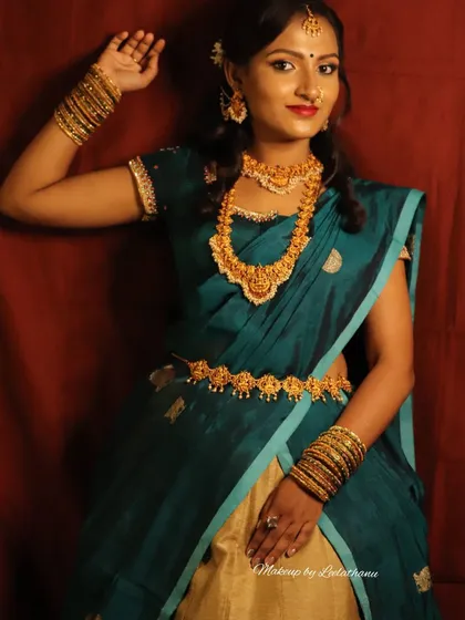 Here you can see the full traditional attire, where the makeup complements the beautiful teal saree and temple jewelry. I guide my students on how to create a balanced look that considers the entire outfit and occasion.